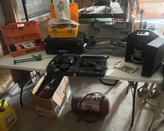 Air tanks, surveying equipment, floor Jack, router, gun case, tile saw and caulk gun