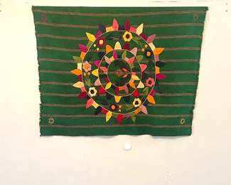 This is a hand-woven and embroidered textile panel, and throw pillows