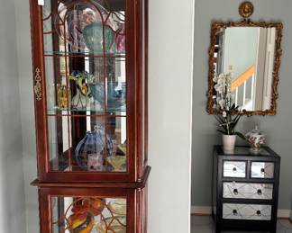 Curio cabinet filled with handblown and signed glass pieces