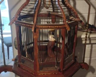 decorative wooden birdcage on a stand