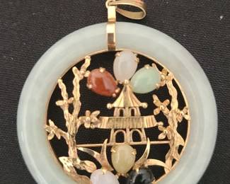 14k gold pendant featuring a jadeite jade disc with a central scene