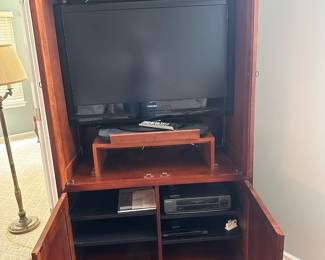 Solid wood armoire / entertainment armoire.  42"w 23"d 76"h.  2 shelves in the bottom.