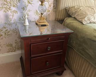 Pair of nightstands, 2 drawers and pull out writing surface, glass top and bun feet.  20"w 17"d 27"h.