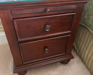 Pair of nightstands, 2 drawers and pull out writing surface, glass top and bun feet.  20"w 17"d 27"h.