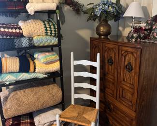 Hand knit afghans, ladder back chair and vintage small armoire