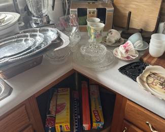 assortment of kitchen appliances, glassware and serving pieces