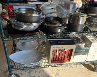 Several sets of flatware and ceramic white serving pieces