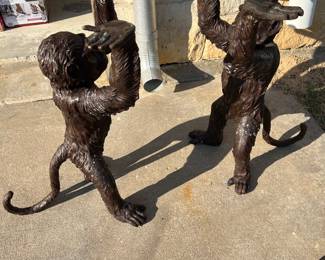 Two bronze monkeys with a glass top make a table!