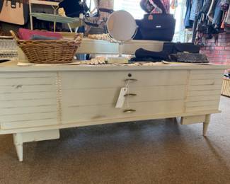 cream colored cedar chest with accents