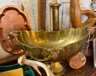 footed brass planter, deer antlers, copper trays, brass candlesticks with globes