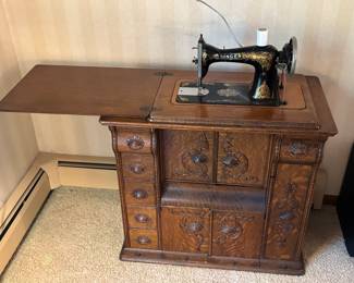 Gorgeous turn of the century sewing machine in tiger oak cabinet