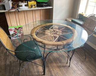 Round glass dining room table with two chairs