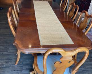 Huge dining room table with eight chairs and two leaves. Currently it is almost 8 foot long with the two leaves.
