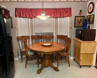 Solid oak clawfoot table with lazy Susan and 6 press back chairs. Island