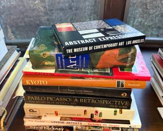 Collection of art books including Abstract Expressionism, Picasso: A Retrospective, David Hockney, Frank Lloyd Wright, and Kyoto.