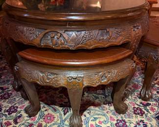 Carved Asian Coffee Table with Nesting Stools
Intricately carved round wood table featuring detailed relief artwork and four matching nesting stools. Beautiful craftsmanship and functional design.
