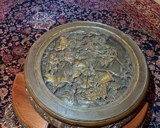 Carved Asian Coffee Table with Nesting Stools
Intricately carved round wood table featuring detailed relief artwork and four matching nesting stools. Beautiful craftsmanship and functional design.