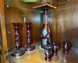 Bohemian Ruby Cut-to-Clear Glass Set
Elegant ruby red etched glass collection featuring vases and goblets with floral designs. Beautiful European craftsmanship—perfect for display.