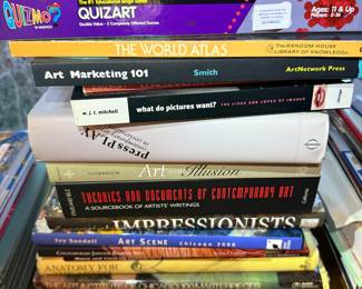 Stack of art reference books including Art Marketing 101, Art and Illusion, Theories and Documents of Contemporary Art, and Monet: A Retrospective.