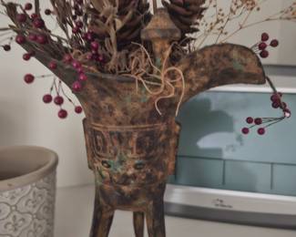 metal cup with flower arrangement