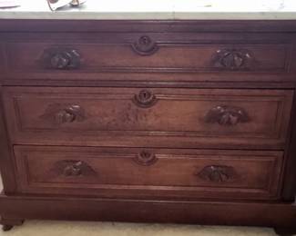 Eastlake-style dresser with a marble top and three drawers