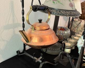 vintage copper tea kettle on iron stand