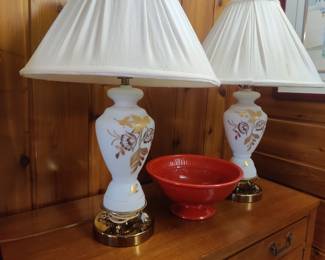 Pair of gold trimmed lamps on 1 of 2 cabinets