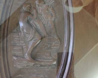 Carved pix under glass on coffee table