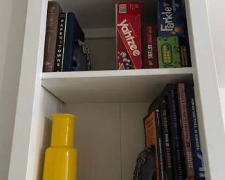 Books, bookends, vases, games. 