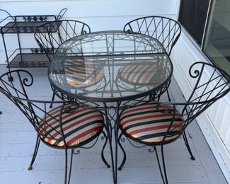 Wrought Iron Indoor/Out door Glass Top Table and Chairs set. This table can separate into two for more versatility. 