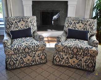 Pair of custom swivel arm chairs.