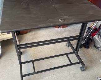 Manually adjustable work station with locking wheels.