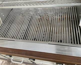 7 feet wide, which is equivalent to 84 inches, 26 inches depth and 36 inches tall in the center where the grill is is 48 inches tall