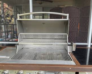 7 feet wide, which is equivalent to 84 inches, 26 inches depth and 36 inches tall in the center where the grill is is 48 inches tall
