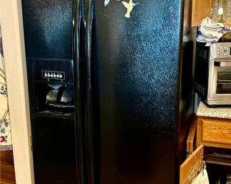 Whirlpool side by side black refrigerator.