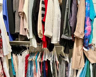MASTER CLOSET WITH MEN'S AND WOMEN'S CLOTHING.