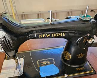 $30  New Home sewing machine and cabinet