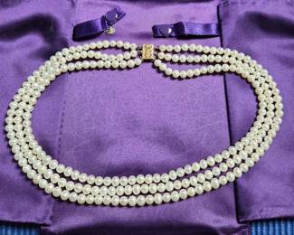 triple strand pearls with gold clasp