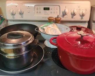Cast iron Dutch oven, stainless and aluminum pots and pans, metal colander 