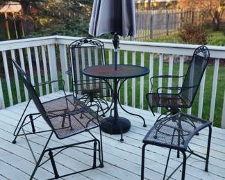 Wrought iron patio table with umbrella, 2 swivel rockers, swinging bench, curved table