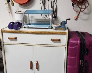 Utility cabinet, hard case luggage, lots of lead cords, rug stretcher, hand weights