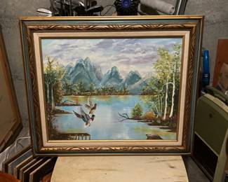 Framed Painting of Flying Ducks over a River Landscape
