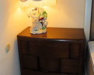 One of two matching three drawer nightstands.
