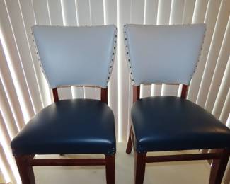 Two matching two tone, blue and white leather like dining chairs.