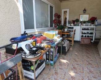 Hundreds of boxed light bulbs, storage cabinets, tools, picnic hamper and supplies.