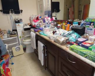 Bathroom contents, personal hygiene items, scales, drawers, medical cushions.