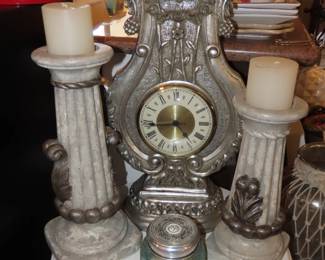 Decorative clock with matching candle sticks.
