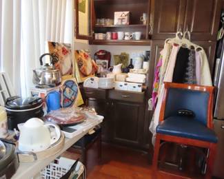 Single bar stool. Stemware, tea kettle, slow cooker, grill, storage boxes.