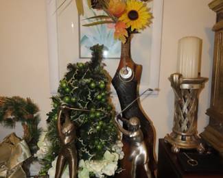 Golf trophies, prelit Christmas tree, carved wooden vase.