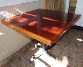 Solid wood table top on metal stand.